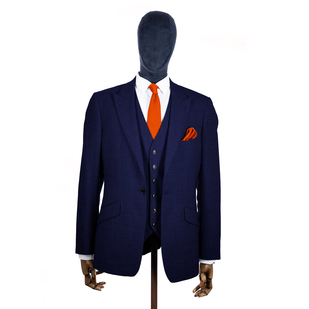 Burnt Orange Knitted tie and pocket square with navy suit on a mannequin - right