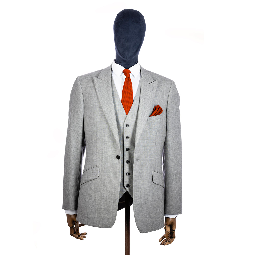Dark Burnt Orange Knitted tie and pocket square with grey suit on a mannequin - centre